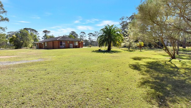 A large brick building with a flat roof, surrounded by a well-maintained grassy area and trees. - Home Among the Gum Trees - Lovedale (Lovedale)