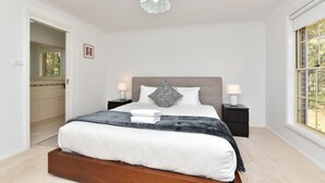 A bedroom with a large bed, bedside lamps, a decorative ceiling light, and a window with a view. - Home Among the Gum Trees - Lovedale (Lovedale)