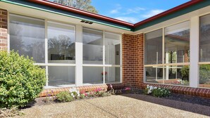 A building with large windows, a brick corner, and a gravel driveway. - Home Among the Gum Trees - Lovedale (Lovedale)