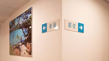 A hallway with directional signs indicating room numbers 107-106 and 107-112.