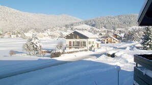 A snow-covered landscape with houses and a clear sky.