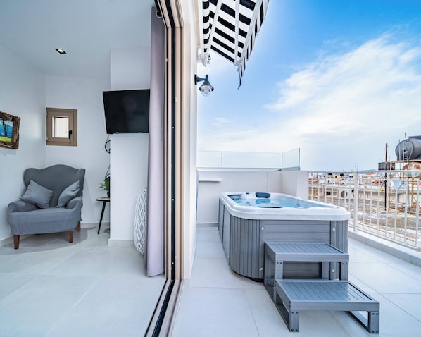 Relax on the balcony with a hot tub and city views.