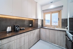 Enjoy a city view from the kitchen window, where you can cook and brew a fresh cup of coffee.
