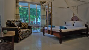 Una habitación con cama, sofá y mesa.