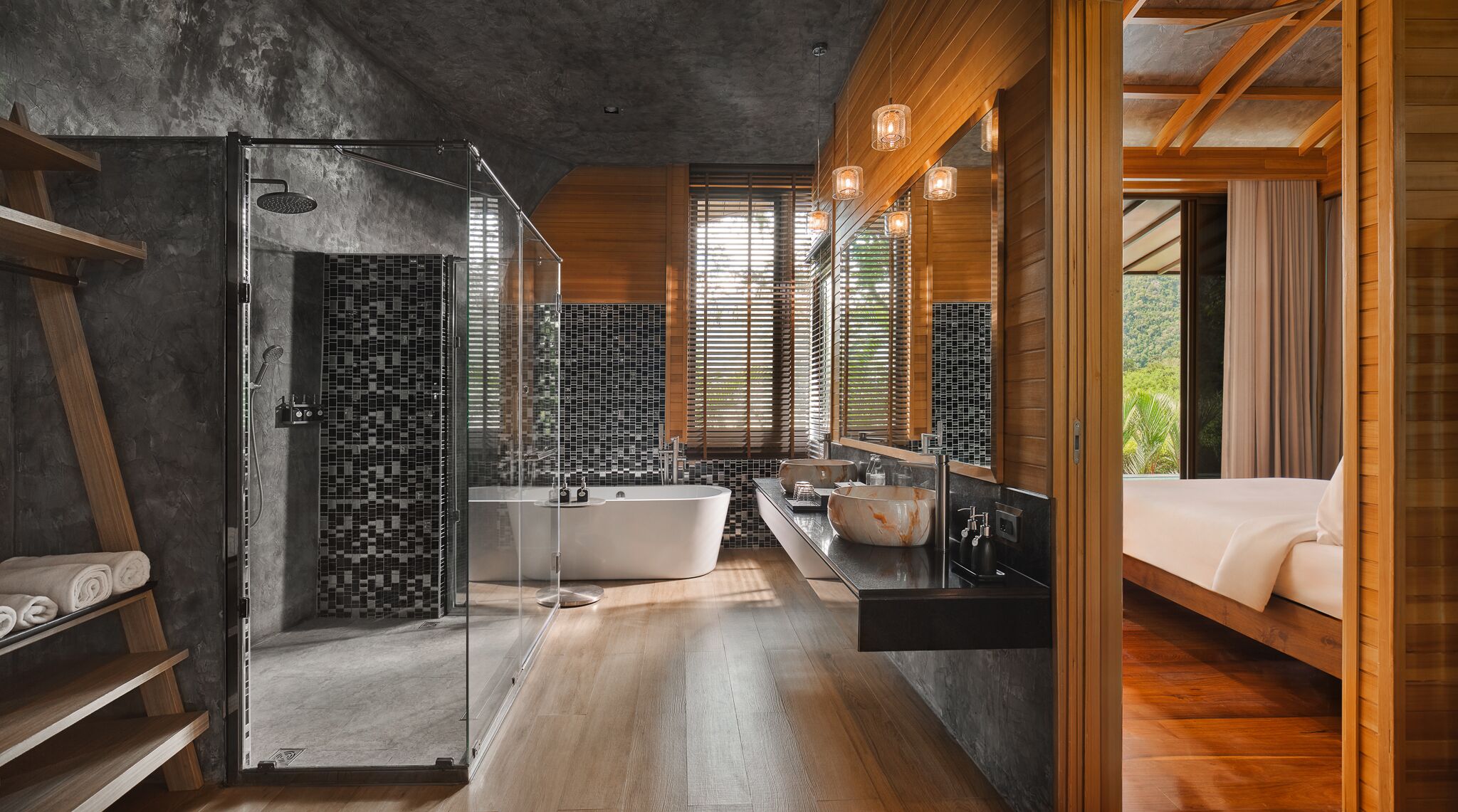 A modern bathroom with a freestanding bathtub, a glass-enclosed shower, and a large mirror.