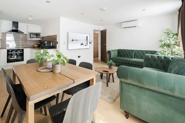 Elegant lounge with LED lighting, AC and 75-inch Smart TV with a Play Station 5.