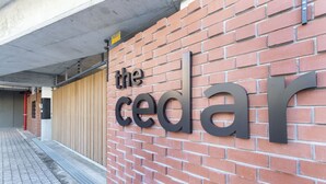 A brick wall with the words "the cedar" in large letters. - The Cedar Unit 105 (Cape Town)