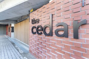 Un muro de ladrillo con las palabras "the cedar" en letras grandes.