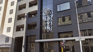 A modern building with a prominent sign reading "The Hotel". - The Tokyo 807 (Cape Town)