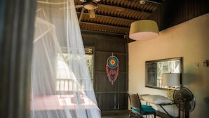 A room with a bed, a chair, a fan, a dreamcatcher, and a window. - Harrera Perhentian Long Beach (Pulau Perhentian Kecil)
