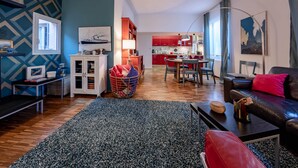 A modern apartment with a living room, kitchen, and dining area.