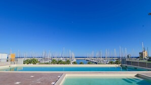 A rooftop pool with a view of a marina and the sea. - Luxury 3B (Santo Stefano al Mare)