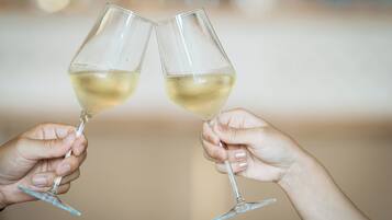 Two hands holding wine glasses.