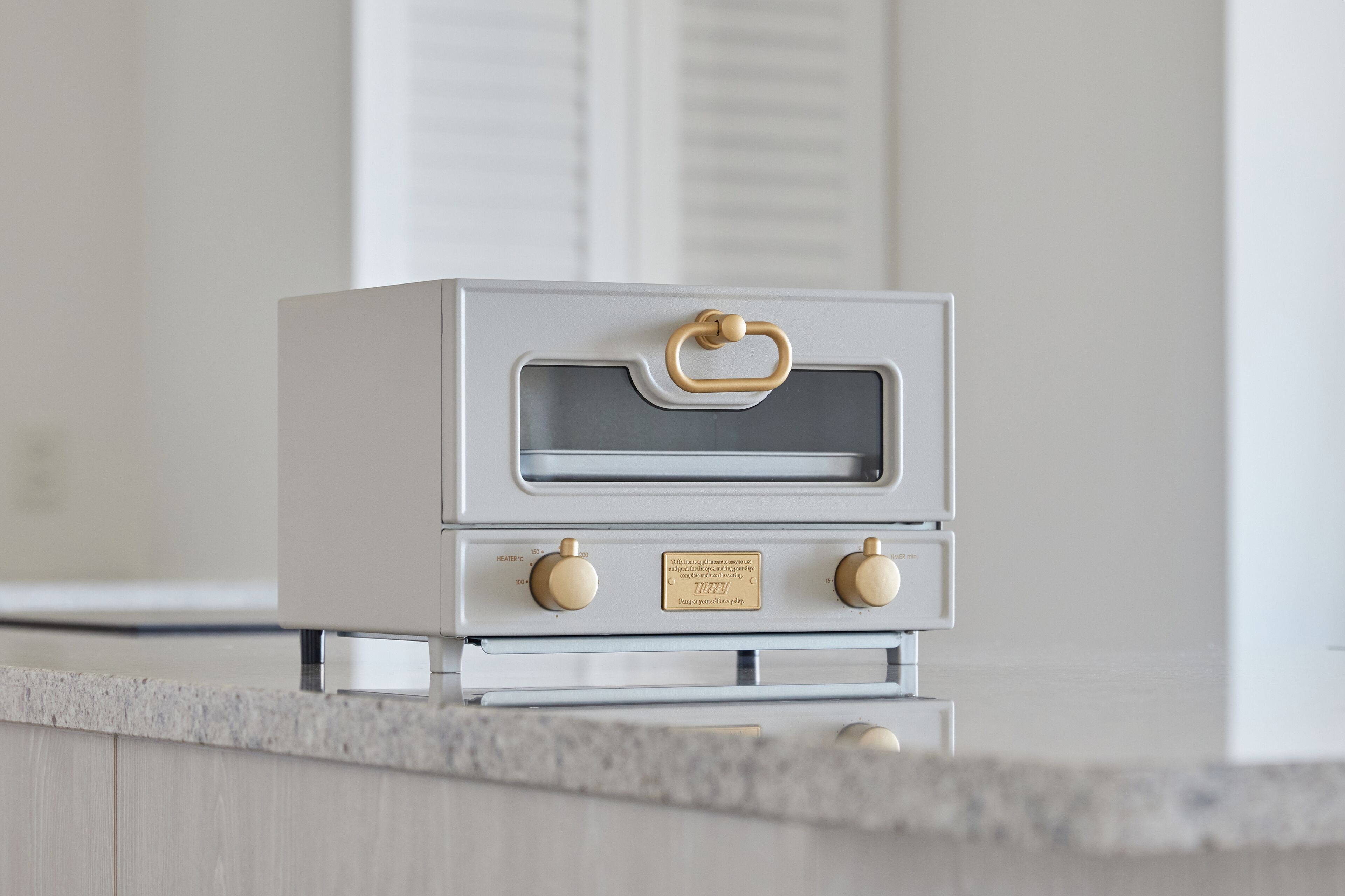 A kitchen with a white oven and a granite countertop.