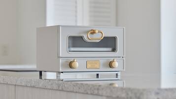A kitchen with a white oven and a granite countertop.