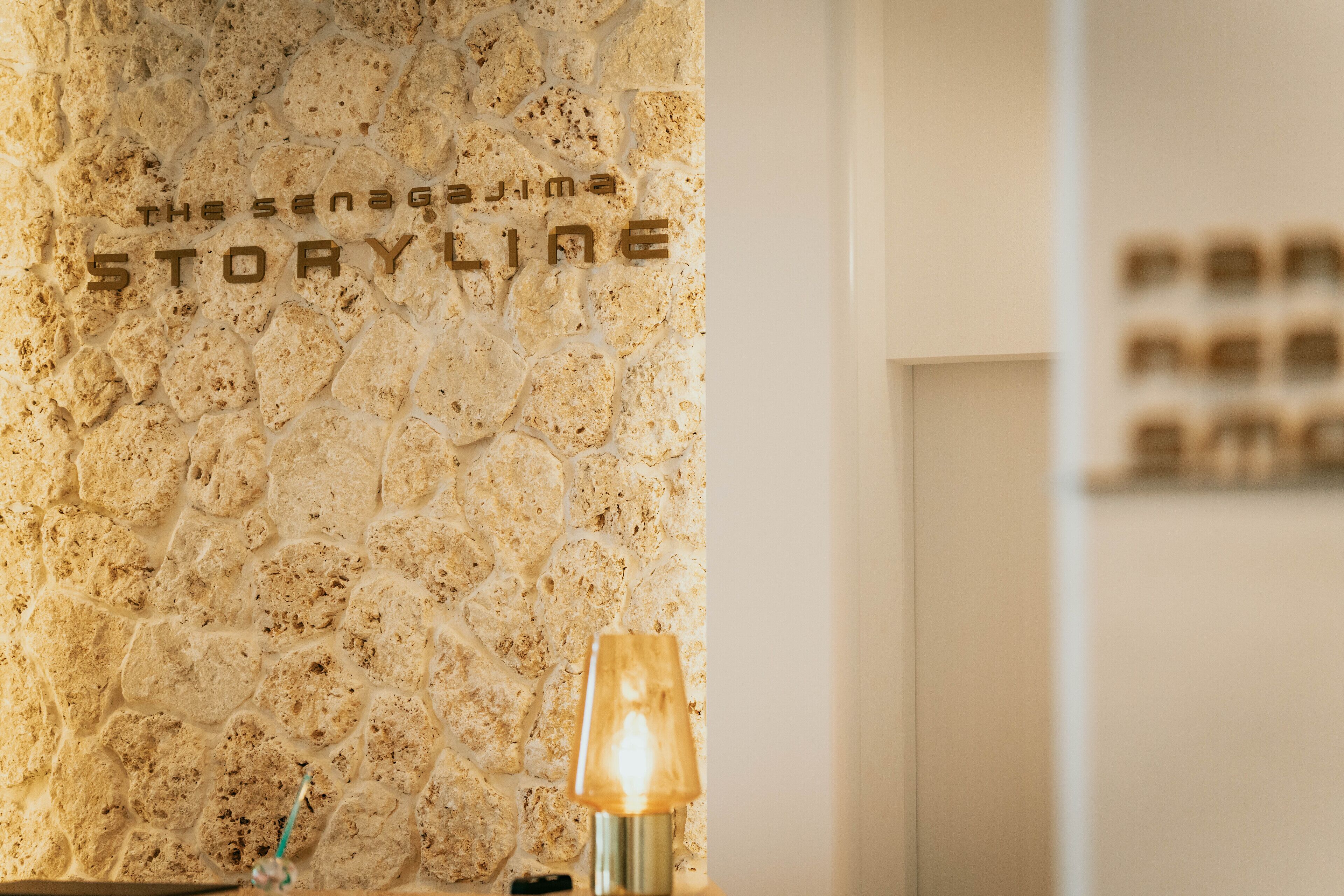 A textured stone wall with the words "The senegajima STORYLINE" visible.