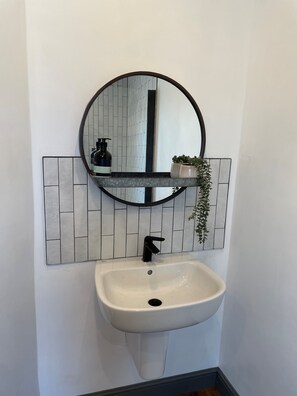 Shower, hair dryer, towels, toilet paper