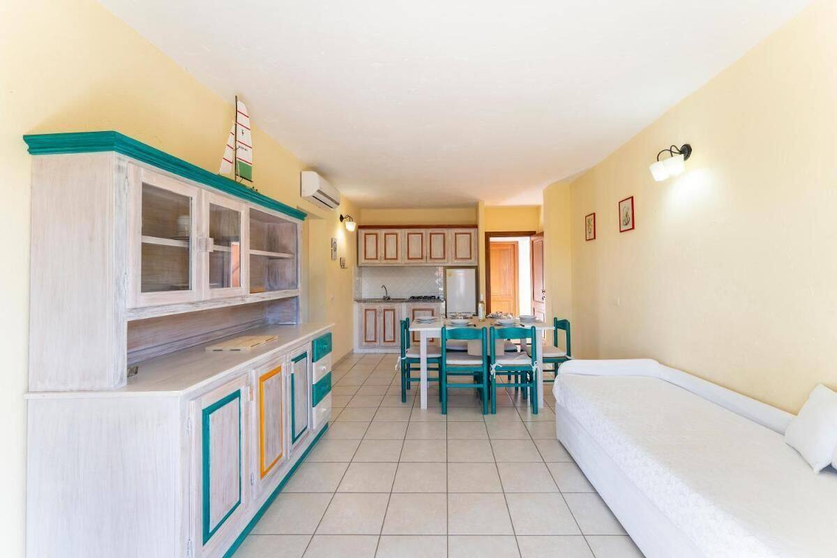 A compact living space with a kitchenette, dining area, and a bed.