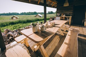 Enjoy meals on the deck with a rustic dining table and benches.