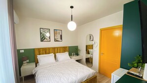 A hotel room with a bed, bedside tables, a mirror, a door, and a window. - Room-three Doors Apartments, Papaya 1-be (Tirana)