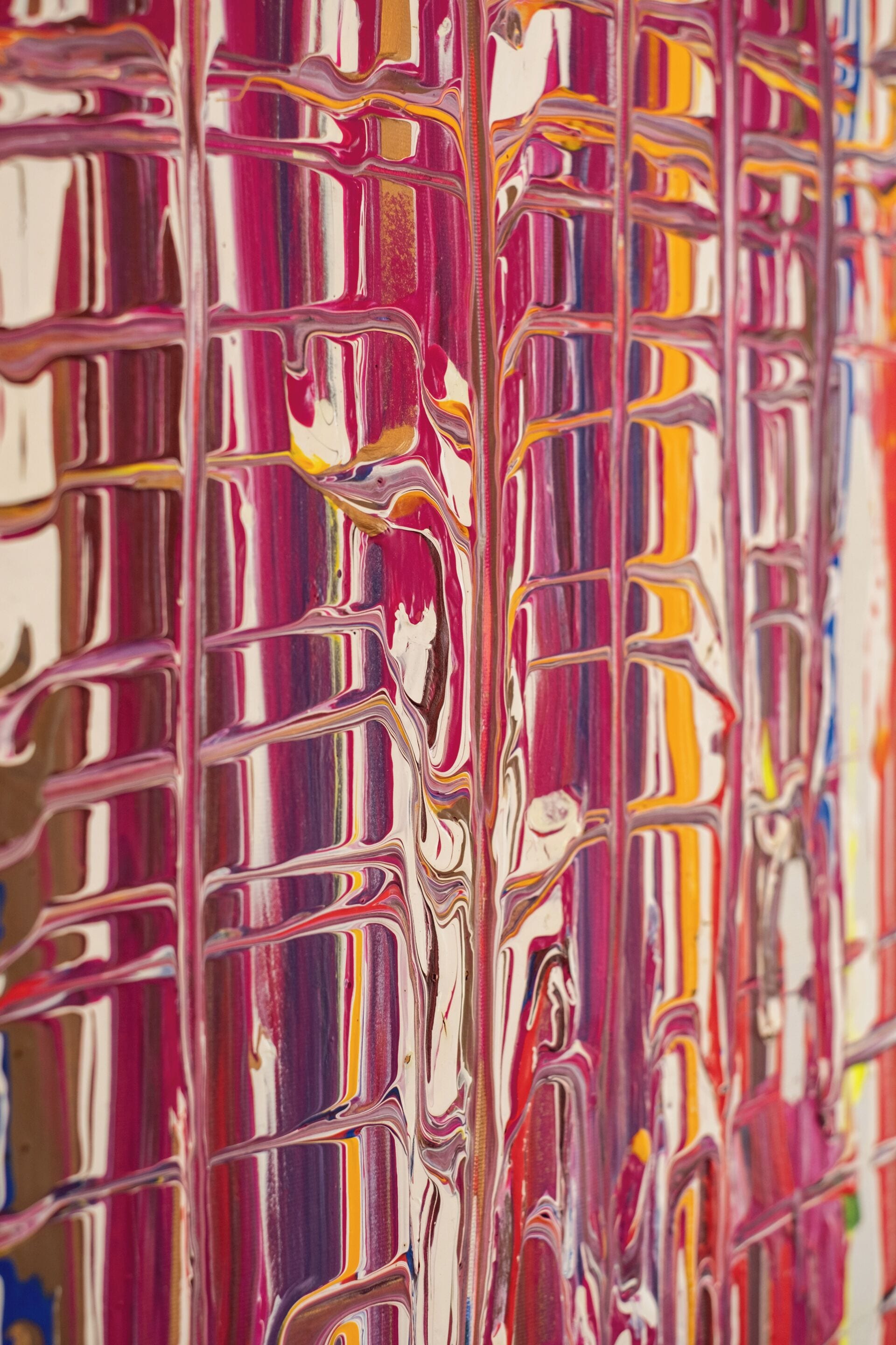 A close-up of a colorful, abstract painting with wavy patterns and vertical lines.