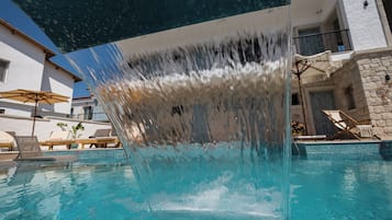 Outdoor pool, open 11:00 AM to 7:00 PM, pool umbrellas, pool loungers
