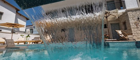 Outdoor pool, open 11:00 AM to 7:00 PM, pool umbrellas, pool loungers