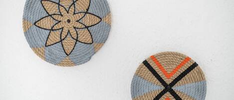 Two circular woven coasters with different patterns.