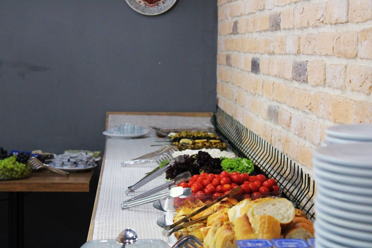 A buffet table with various food items and utensils.