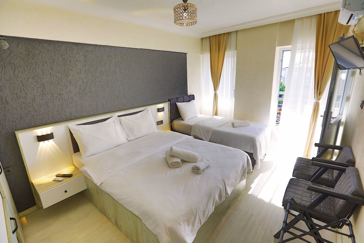 Comfort Triple Room, Balcony, City View | In-room safe, individually decorated, individually furnished, desk