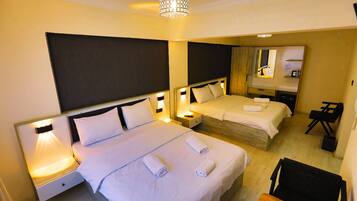 Standard Quadruple Room | In-room safe, individually decorated, individually furnished, desk