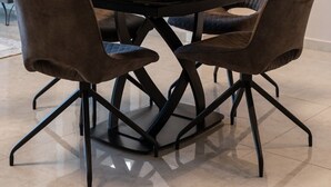 A dining area with a round table, six chairs, and a large vase centerpiece. - Enchanting 2 Bedroom In Best Location/Parking (Jerusalem)