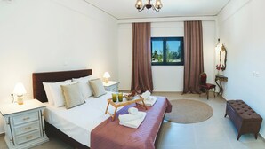 A bedroom with a bed, bedside tables, a nightstand, a window with curtains, a round rug, a bench, and a mirror. - Anemoessa Mansion in Rhodes Old Town (rhodes)