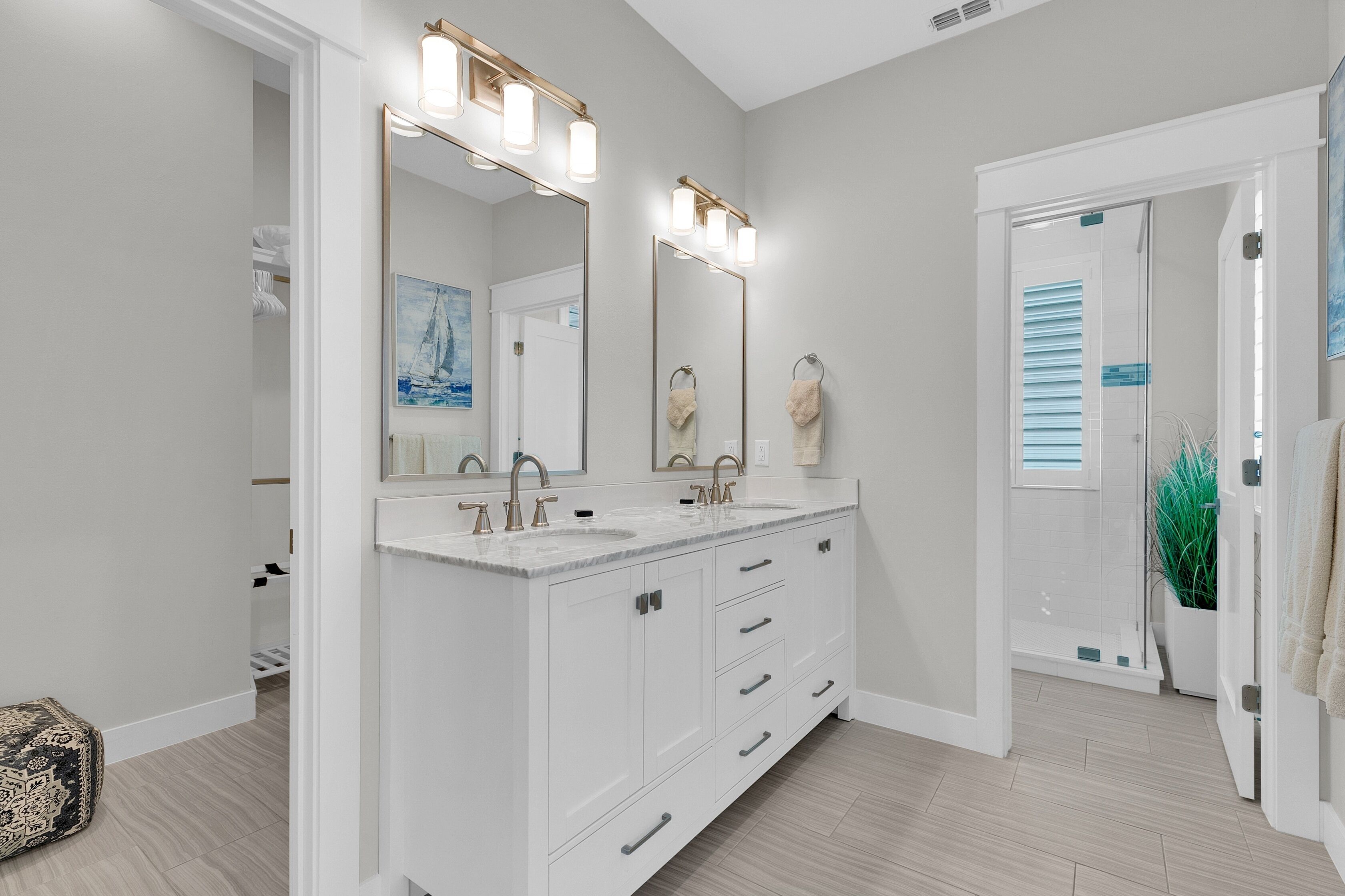 A modern bathroom with a large vanity, two sinks, and a large mirror.