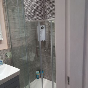 Shower, hair dryer, towels, soap