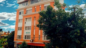 A multi-story hotel with a red and white facade, featuring a prominent rooftop terrace and a sign for 'DEEP JYOTI INN'. - Deepjyoti Inn & Homestay (Kathmandu)