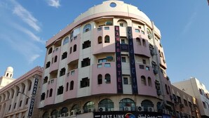 A multi-story hotel with a curved facade, multiple balconies, and a prominent sign for the RAHAB HOTEL. - RAHAB HOTEL (Dubai)