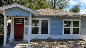 A single-story house with a red door and white trim, numbered 1103. - Pet friendly!  Close to Temple hospitals. (Temple)