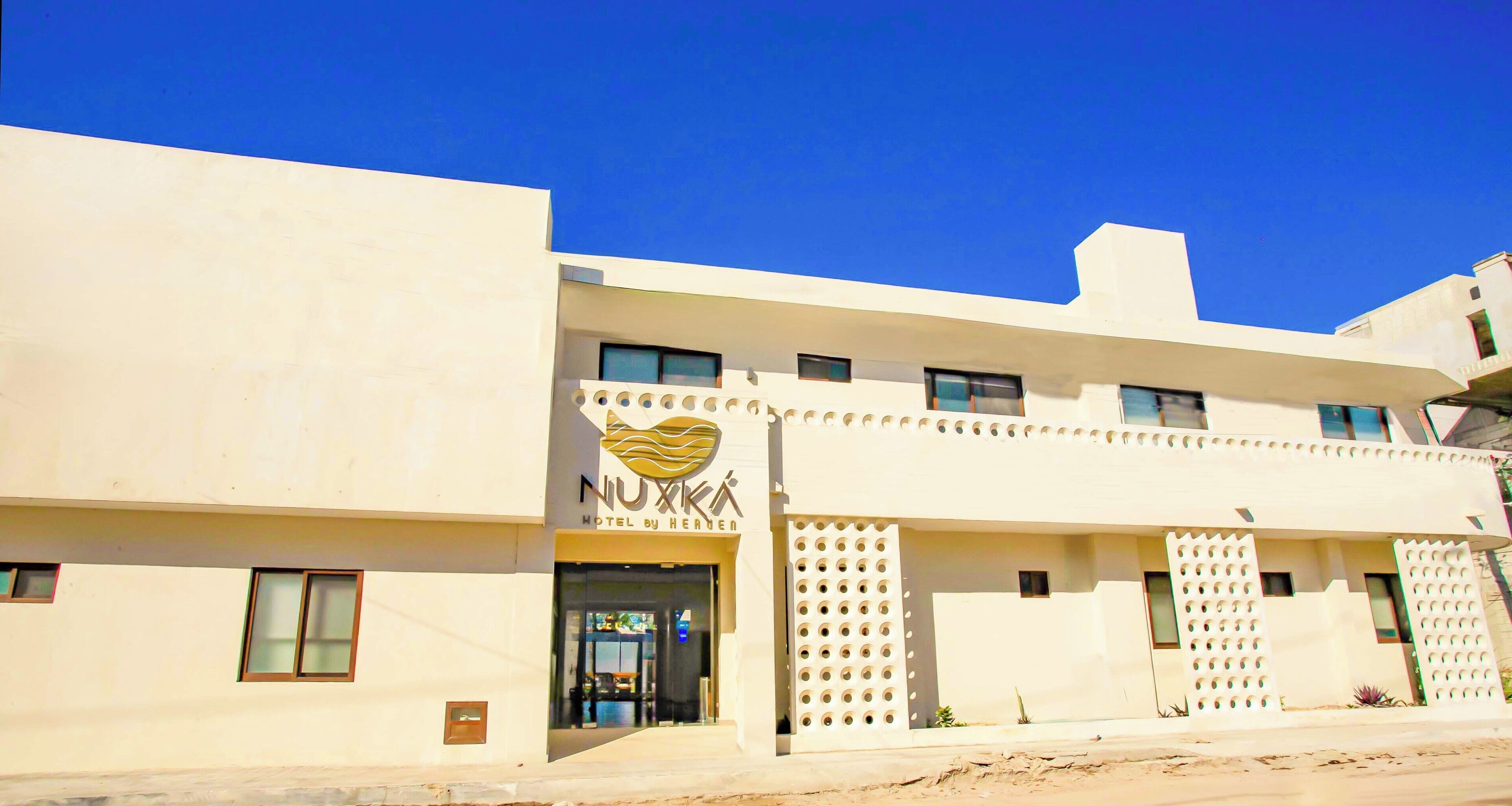 A hotel with a modern facade, a prominent logo, and a clear entrance.