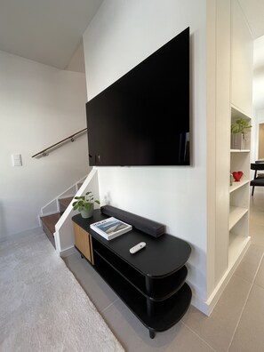 Relax in this stylish living space with a flat-screen TV and comfortable seating area.