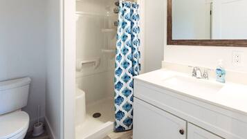 Shower, hair dryer, towels, toilet paper