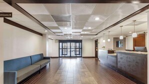 A spacious lobby with a reception desk, a waiting area with a sofa, and a clear view of the entrance. - Comfort Inn Dallas North Love Field Airport (Dallas)