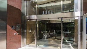 A modern building entrance with a glass door and a metal frame.