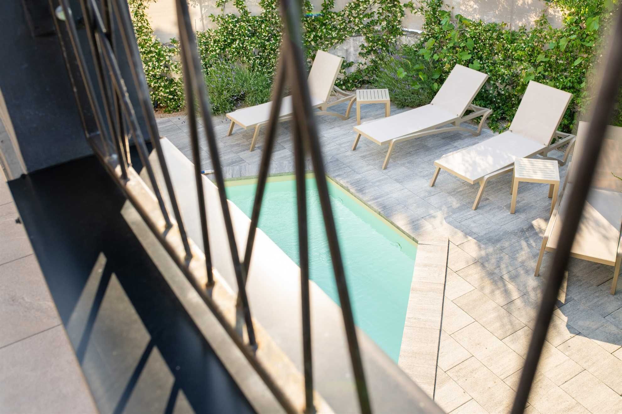 A poolside area with lounge chairs and a swimming pool.