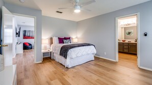 A bedroom with a bed, bedside tables, a ceiling fan, and a walk-in closet. - #Rental Welcomes #Nurses #Sea World #JBSA #Medical Center #USAF #ARMY #BMT #NSCA (San Antonio)