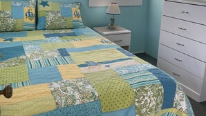 A bedroom with a large bed, a dresser, a nightstand, and a window with blinds. - Cozy cabin less than 100 steps to the sand! (Hampton)