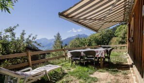 Relax under a shaded patio with scenic views of the surrounding mountains.