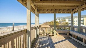 A wooden deck with a view of the beach and ocean. - First Floor Pebble Beach
3BR/2BA Oceanview Condo 
Steps from the Beach
 (Emerald Isle)