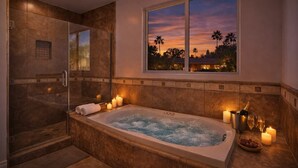 A modern bathroom with a large bathtub, a glass shower enclosure, and a view of palm trees at sunset. - Granada Hills Estate | Lap Pool, Spa & Guesthouse (Los Angeles)