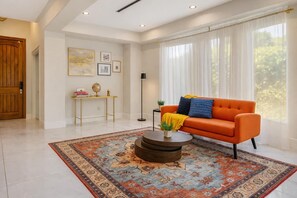 A modern living room with a sofa, coffee table, and a patterned rug. - Granada Hills Estate | Lap Pool, Spa & Guesthouse (Los Angeles)
